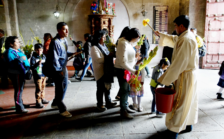 A priest blesses worshipers after Palm Sunday Mass April 9 in La Paz, Bolivia. (CNS/Reuters/David Mercado)