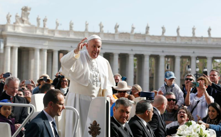 Pope Francis greets the crowd as he arrives to lead his general audience in St. Peter's Square at the Vatican April 26. (CNS photo/Paul Haring)