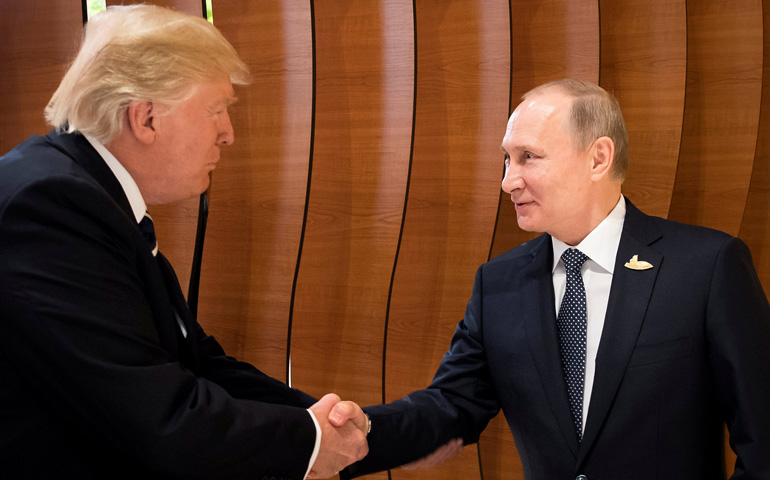 President Donald Trump and Russian President Vladimir Putin shake hands during the Group of 20 meeting in Hamburg, Germany, July, 7. (CNS/Handout via Reuters)