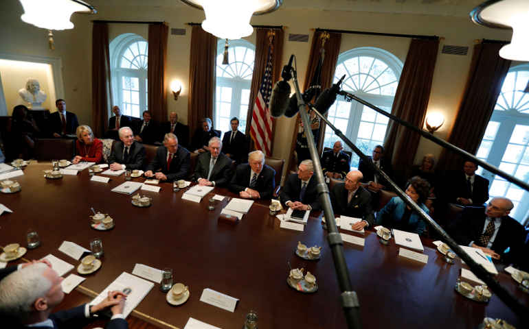 Microphones hover overhead as U.S. President Donald Trump delivers remarks to reporters before a meeting with his cabinet at the White House March 13. (Reuters/Jonathan Ernst)