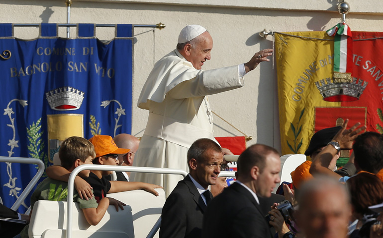 Boys ride in the popemobile as Pope Francis arrives to lead his general audience Wednesday in St. Peter's Square at the Vatican. (CNS/Paul Haring)