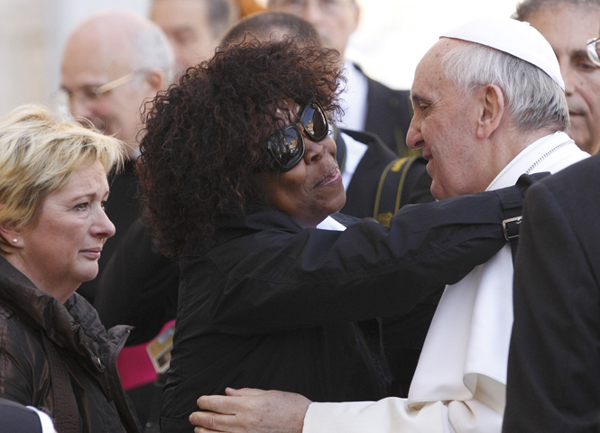 Patience Dodo of Gabon, who is blind, hugs Pope Francis on Wednesday as he leaves his general audience in St. Peter's Square at the Vatican. (CNS/Paul Haring)