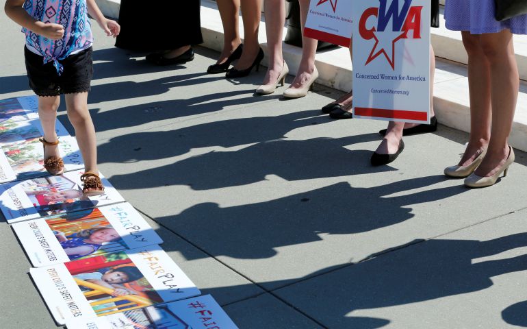 Activists rally outside U.S. Supreme Court in Washington June 26 after the court sided with Trinity Lutheran Church in Columbia, Mo., which sued after being denied a state grant for creating a safer playground. (CNS photo/Yuri Gripas, Reuters) 