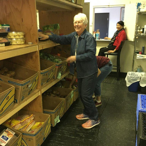 St. Margaret's Center food pantry volunteers Diane Dumond, left, and Marcellana Cojuangco stock shelves. (Photo courtesy of St. Margaret's Center)