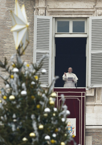 The Christmas tree decorates St. Peter's Square as Pope Francis leads an Angelus from the window of his studio overlooking the square at the Vatican on Dec. 22, 2013. (CNS/Paul Haring)