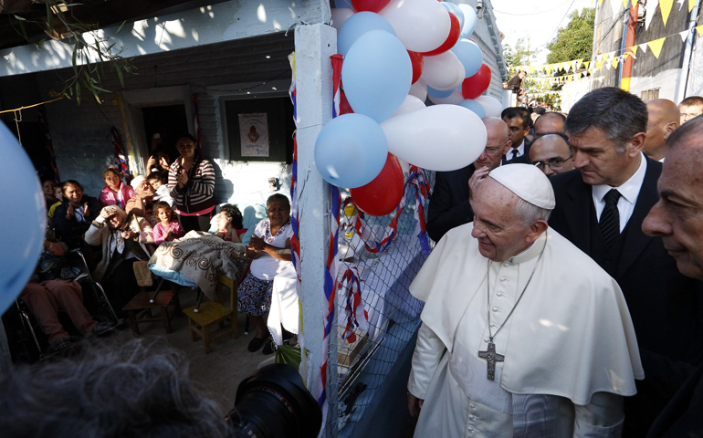 Pope Francis arrives to meet people gathered at a house as he visits Banado Norte, a poor neighborhood in Asuncion, Paraguay, on July 12. (CNS/Paul Haring)