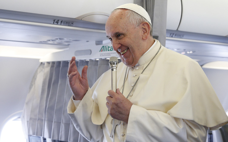 Pope Francis greets media aboard the papal flight from Rome on Tuesday before arriving to speak at the European Parliament in Strasbourg, France. (CNS/Paul Haring)