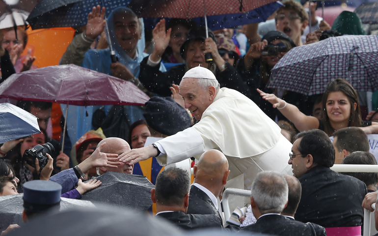 Pope Francis greets people as he arrives to lead his general audience in St. Peter's Square at the Vatican Oct. 9. (CNS/Paul Haring)