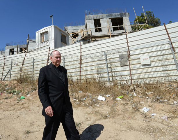 Bishop Richard Pates of Des Moines, Iowa, walks along the Israeli settlement construction Sept. 12 in Sheikh Jarrah in East Jerusalem. (CNS/Debbie Hill)