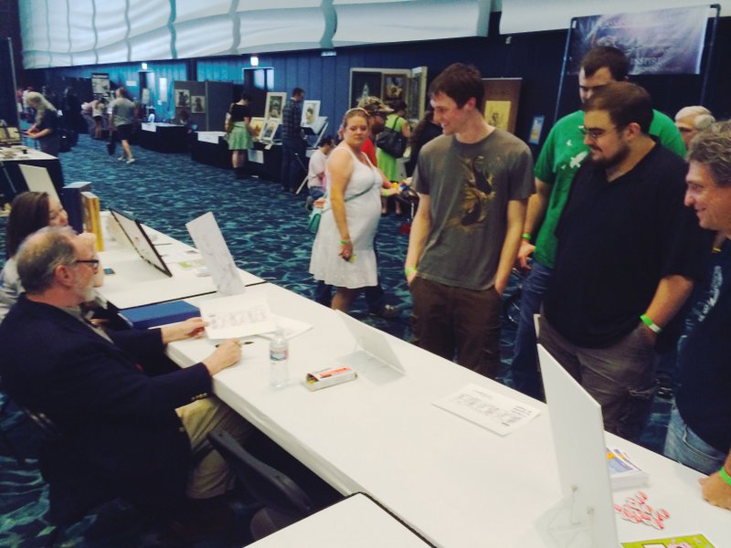 "Francis" and Marrin drew many artists and other visitors to GoComic table. (Photos by Tom Fox)