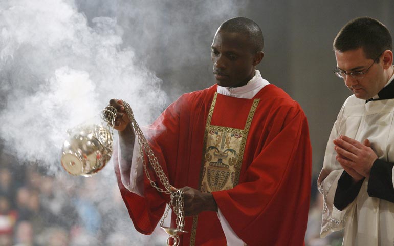 Deacon Luta Nsubuga waves a censer during a 2010 Mass at the Basilica of the National Shrine of the Immaculate Conception in Washington. (CNS/Nancy Wiechec)