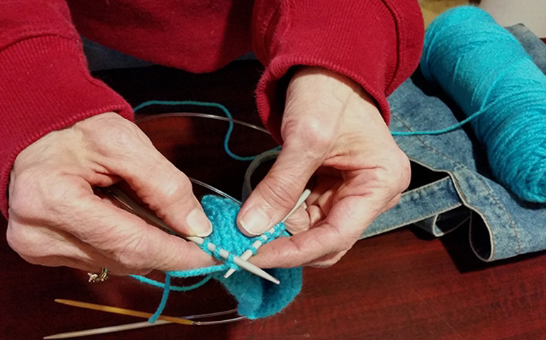 It takes Nora Schindler about 90 minutes to knit a tiny hat that will warm the head of a newborn at St. Joseph Medical Center in Tacoma. (Courtesy Holy Disciples Parish)