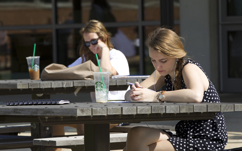 Young women break from classes outside the student center known as the Pryz on the campus of The Catholic University of America in April. (CNS/Nancy Phelan Wiechec) 