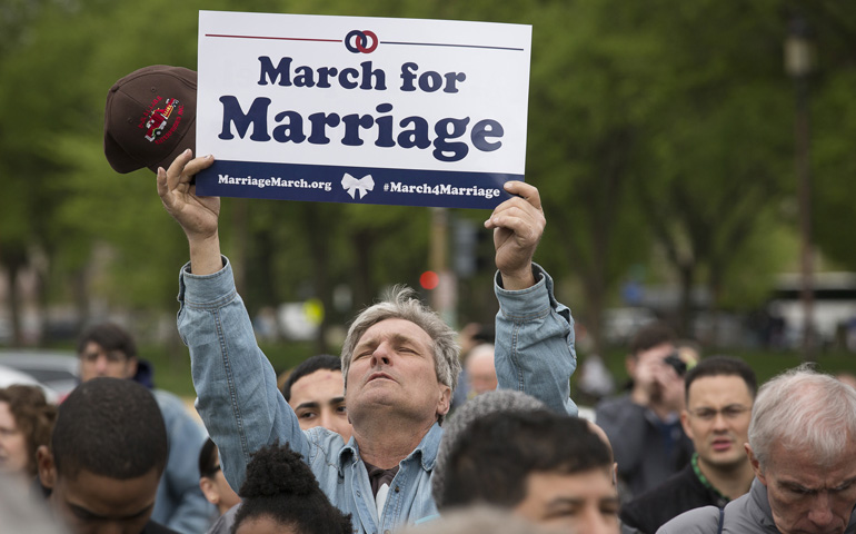 A man holds a sign supporting traditional marriage Saturday near Capitol Hill in Washington during the third annual March for Marriage. (CNS/Tyler Orsburn)