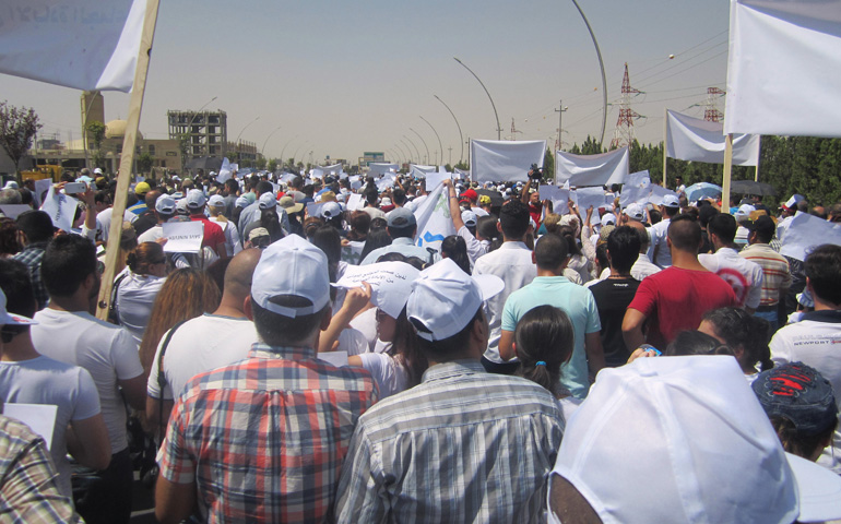 Christian refugees march against persecution by Islamic State fighters July 24 outside the U.N. compound near the airport in Irbil, Iraq. (CNS/Sahar Mansour)