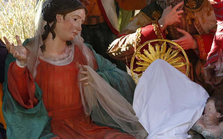 Mary looks at the covered baby Jesus in the Nativity scene Monday in St. Peter's Square at the Vatican. The Nativity scene, created by artisans from Naples, will be unveiled Christmas Eve. (CNS/Paul Haring)