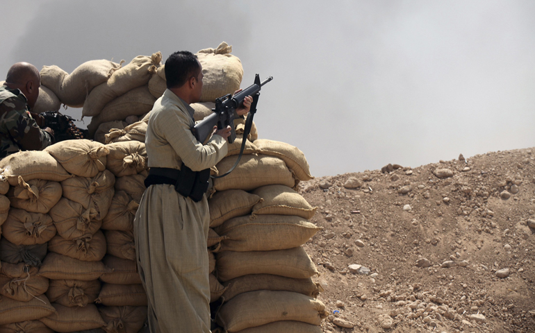 Kurdish "peshmerga" troops stand guard against Islamic State militants Wednesday on the outskirts of the province of Ninevah, Iraq. (CNS/Reuters)