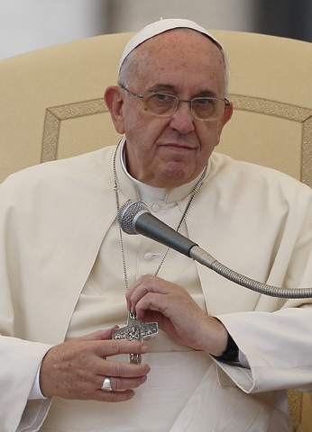 Pope Francis holds his pectoral cross as he leads his general audience Wednesday in St. Peter's Square at the Vatican. (CNS/Paul Haring)