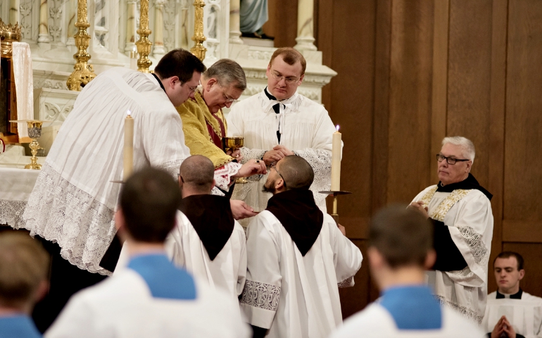 Cardinal Raymond Burke distributes Communion during a Mass in the extraordinary form on Feb. 9 in Kansas City, Kan. (NCR photo/George Goss)