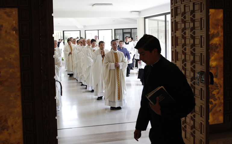 Legionaries of Christ priests wait to enter the chapel at Regina Apostolorum University during a Mass Friday with members of Regnum Christi in Rome. Members of Regnum Christi, the lay movement associated with the Legionaries, met in Rome June 6-9 to discuss the identity of the movement and draft new regulations for it. (CNS/Paul Haring)