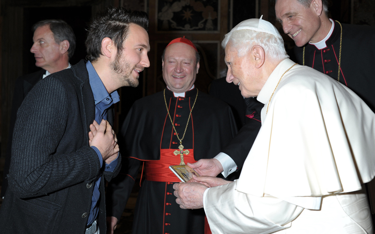 Francesco Lorenzi, lead singer of the Italian rock group The Sun, presents a CD of the band's latest album to Pope Benedict XVI on Thursday at the Vatican. Band members met the pope after performing the previous day to open the plenary meeting of the Pontifical Council for Culture. (CNS/L'Osservatore Romano)