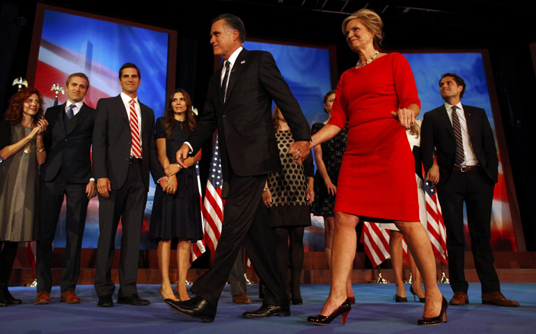 U.S. Republican presidential nominee Mitt Romney walks off stage with his wife, Ann, after delivering his concession speech Wednesday in Boston. (CNS/Reuters/Eric Thayer)