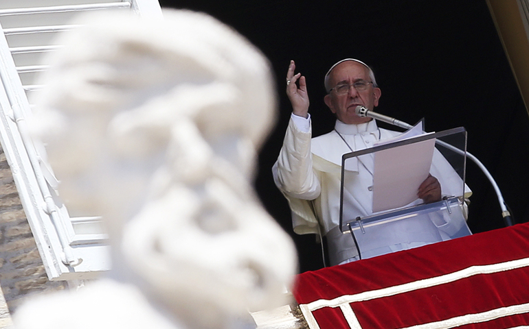 Pope Francis gives a blessing as he leads the Angelus Aug. 18 from a window in the Apostolic Palace at the Vatican. (CNS/Reuters/Alessandro Bianchi)