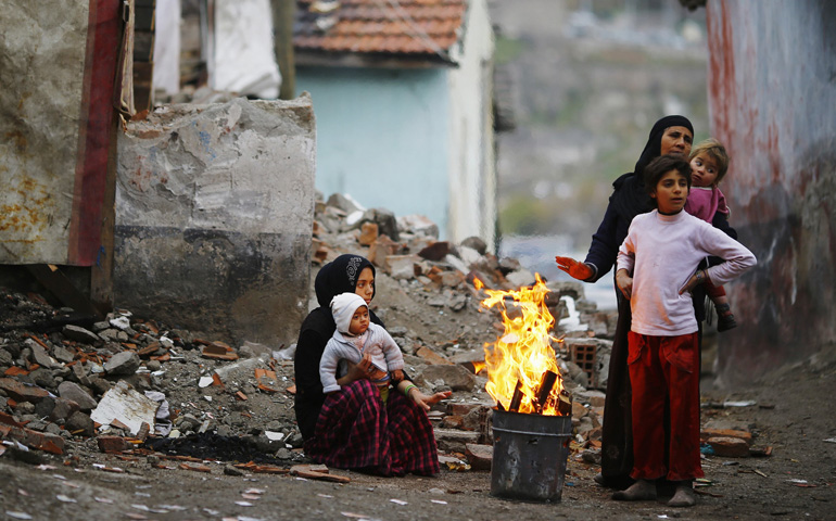 Syrian refugees warm themselves around a fire Dec. 3 in Ankara, Turkey. (CNS/Reuters/Umit Bektas)