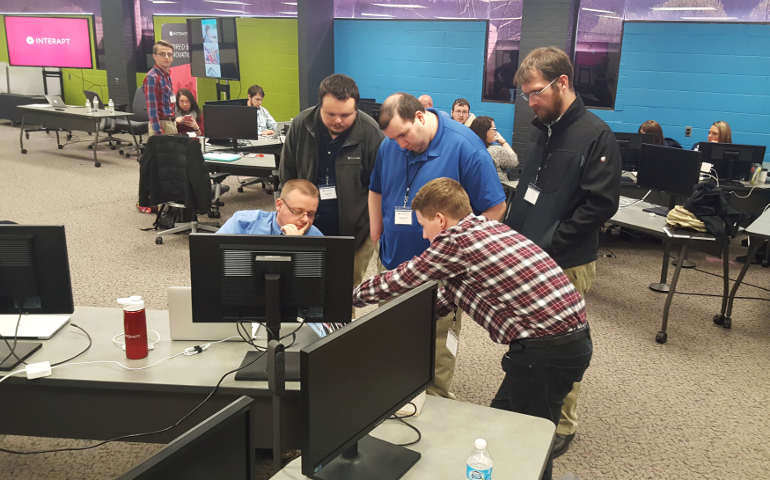 Rigel Preston (seated left), a former surface coal miner, works with other Interapt trainees at the company's office in Paintsville, Kentucky, March 13. (Reuters/Valerie Bolcovici)