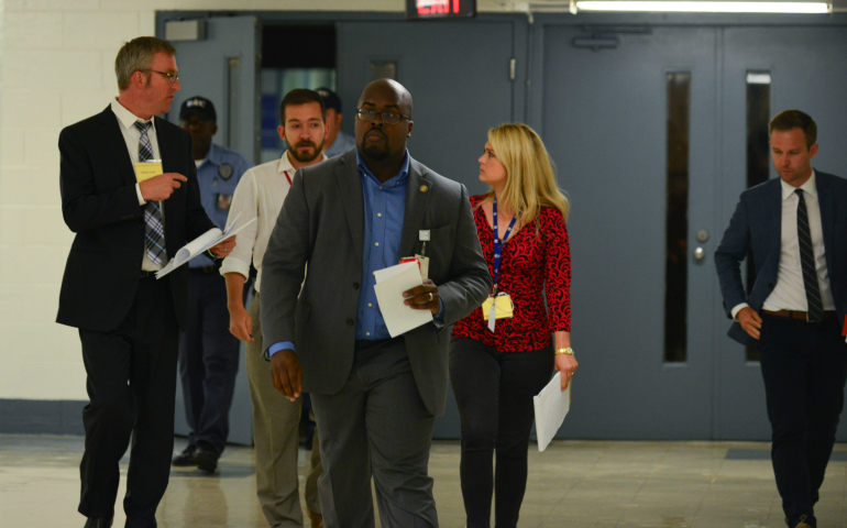 Solomon Graves, Arkansas Department of Correction spokesman, walks ahead of witnesses John Moritz, left, from the Arkansas Democrat-Gazette, Sean Murphy, AP, and Marine Glisovic, KATV, discussing the April 20 execution of Ledell Lee. (Newscom/Zuma Press/Miguel Juarez Lugo)