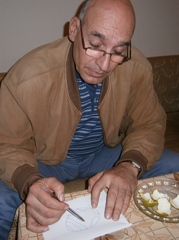 Michel George Sarkisiyan draws a map Nov. 15 at his apartment in Istanbul, Turkey, of the Syrian city of Aleppo, which he was forced to flee in October because of the civil war in his homeland. He and his family have run out of money and are concerned for their future in a foreign country. (CNS/James Martone) 