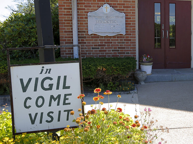 A sign marks the vigil at St. Frances Xavier Cabrini Roman Catholic Church in Scituate, Mass., on July 22, 2015. (Reuters/Brian Snyder)