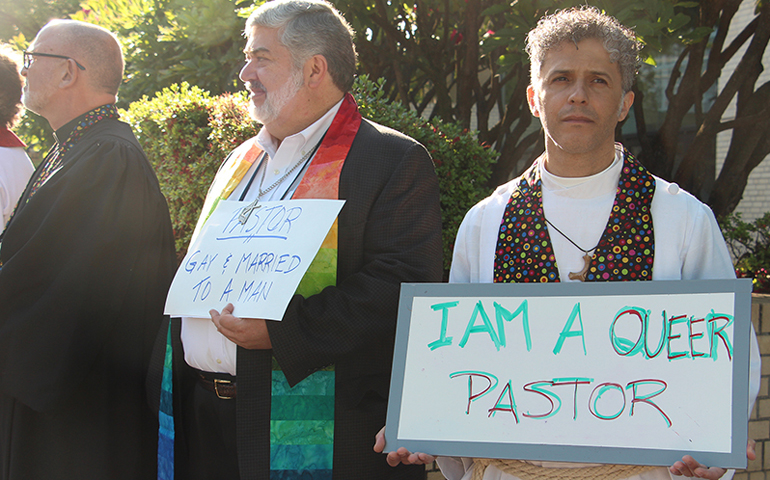 More than 160 demonstrators greeted delegates with a silent protest for LGBT inclusion in the United Methodist Church as they arrived on May 18, 2016, at the Oregon Convention Center for the United Methodist General Conference. Some held crosses draped in stoles from the Shower of Stoles project, each representing the life of an LGBT person in ministry. (RNS/Emily McFarlan Miller)
