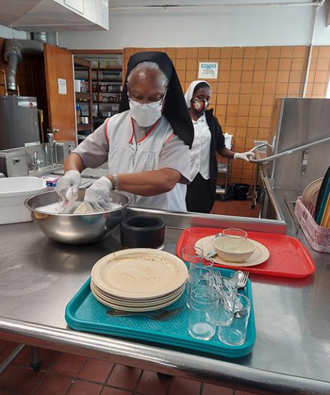 Holy Family Sr. Jean Martinez takes a break from her pastoral care ministry at Chateau de Notre Dame nursing home to help with washing pots. (Courtesy of Jean Martinez)