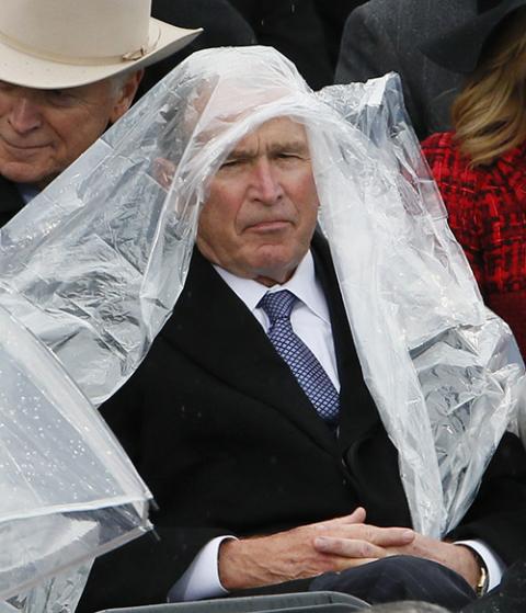 Former President George W. Bush keeps covered in the rain during Donald Trump's presidential inauguration Jan. 20, 2017, at the U.S. Capitol in Washington. (CNS/Reuters/Rick Wilking) Former President George W. Bush keeps covered in the rain during Donald Trump's presidential inauguration Jan. 20, 2017, at the U.S. Capitol in Washington. (CNS/Reuters/Rick Wilking)