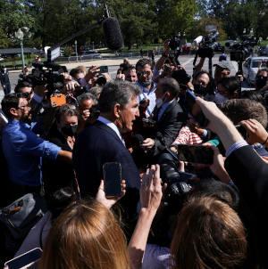 Sen. Joe Manchin, D-W.Va., makes his way through a crowd of Capitol Hill reporters outside the U.S. Capitol in Washington Sept. 30, 2021. (CNS photo/Leah Millis, Reuters)