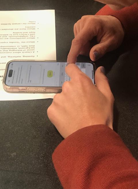 A participant prepares to vote and comment in real time via cellphone at the third modeling session for the Baltimore Archdiocese's Seek the City parish planning process March 22 at Our Lady of Victory in Arbutus, a Baltimore suburb. (OSV News/Catholic Review/Christopher Gunty)