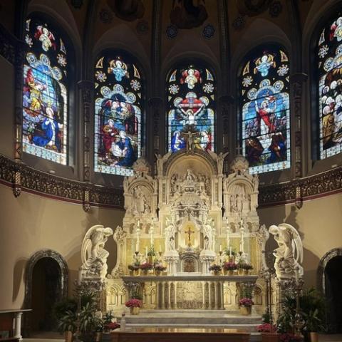 Chicago same-sex blessing apology Ornate altar and stained glass windows.