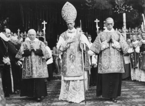 Pope Pius XII. Black and white photo of Pius XII processing in regalia.