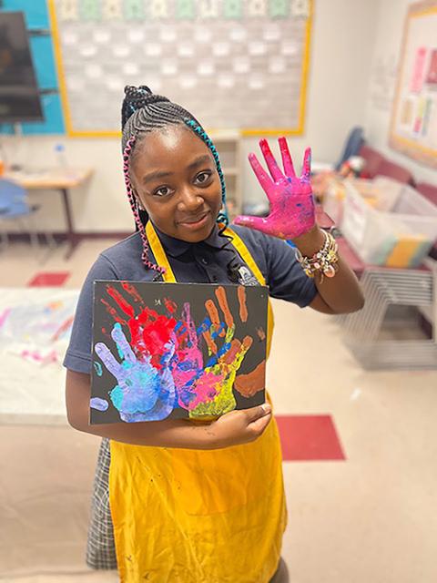 A student at Washington School for Girls holds an art project. (Courtesy of Washington School for Girls)