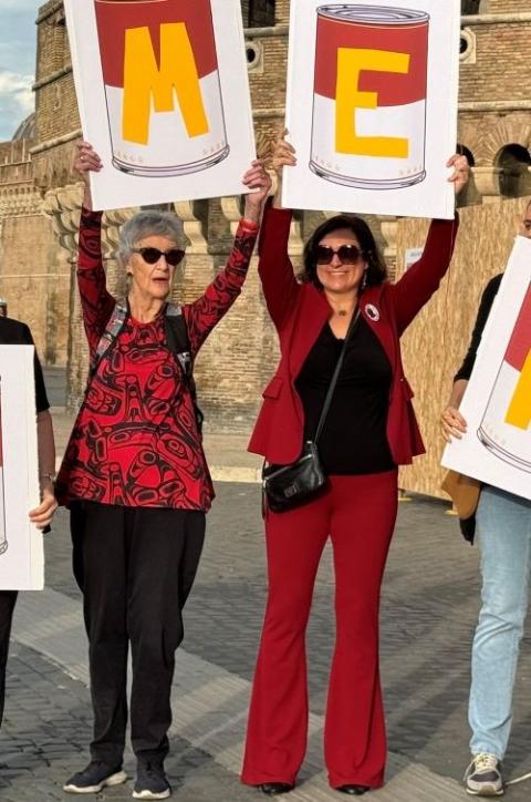 Rosemary Ganley, left, and the Rev. Angela Nevitt Meyer hold letters as part of a group that spelled out "Ordain Women" near St. Peter's Basilica as the synod on synodality began Oct. 2 at the Vatican. (NCR photo/Rhina Guidos)