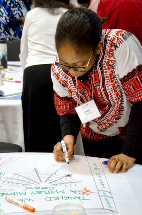 Woman works on art project.