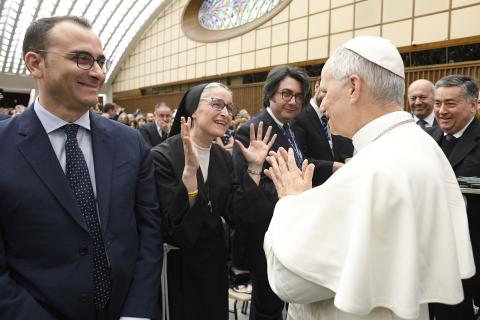 Franciscan Sr. Veronica Donatella, who provides Italian sign language interpretation for Vatican Media, applauds Pope Leo XIV using sign language. (CNS/Vatican Media)