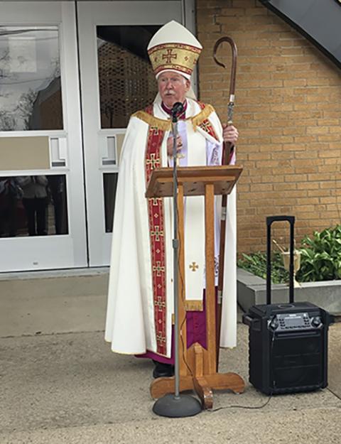 Auxiliary Bishop Mark Eckman celebrates the blessing of the first array of solar panels at St. Catherine of Siena Church in the Diocese of Pittsburgh on April 26. (Theresa Doerfler)