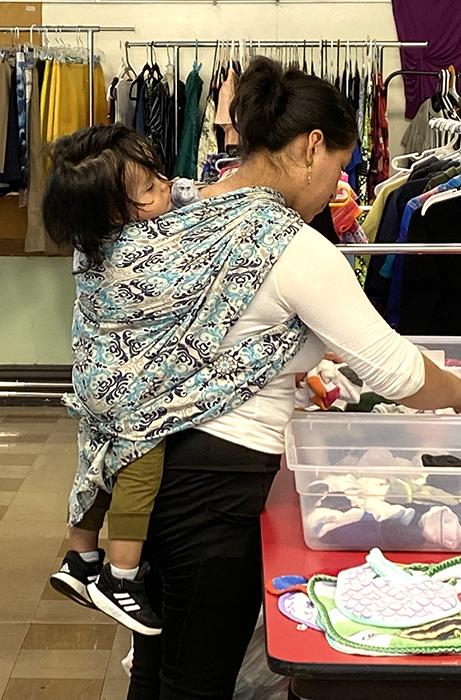 A migrant mother and her child shop for much needed clothing at a Migrant Ministry "free store."  (Courtesy of Migrant Ministry)