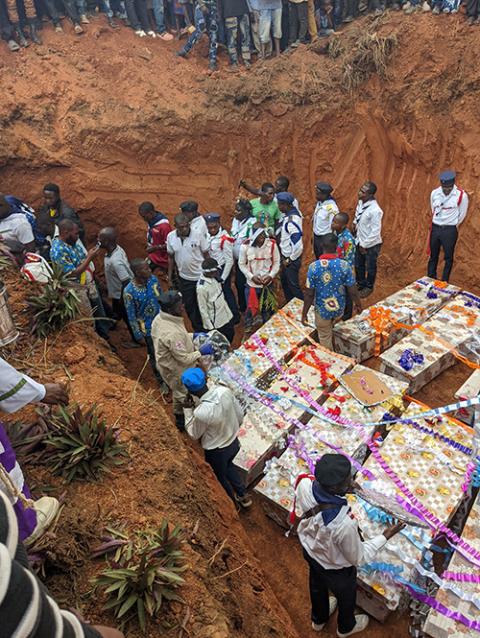 Civilians stand around caskets during a burial in Komanda, in Congo's province of Ituri, July 28, for victims of a horrific attack on the Catholic church in Komanda, where at least 40 faithful were shot or killed with machetes during an overnight vigil in the church July 27. (OSV News/Reuters)