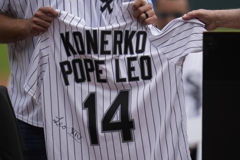 Cardinal Blase Cupich, right, presents former Chicago White Sox player Paul Konerko with a jersey Cardinal Blase Cupich, right, presents former Chicago White Sox player Paul Konerko with a jersey
