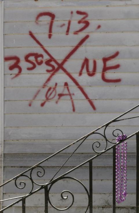 Mardi Gras beads hang outside a vacant house in New Orleans in March 2006. 