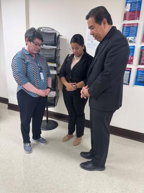 Sr. Leticia Gutiérrez Valderrama, left, joins El Paso Auxiliary Bishop Anthony Celino, as they pray with a woman in a room at an immigration court in El Paso June 25. (Courtesy of Hope Border Institute) 