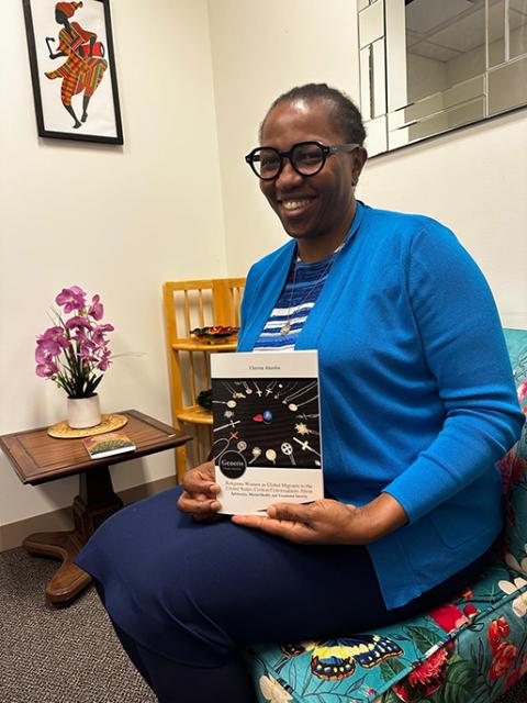In this undated photo, Living Word Sr. Chioma Ahanihu poses with her newly published book Religious Women as Global Migrants to the United States. (Courtesy of Sr. Chioma Ahanihu)